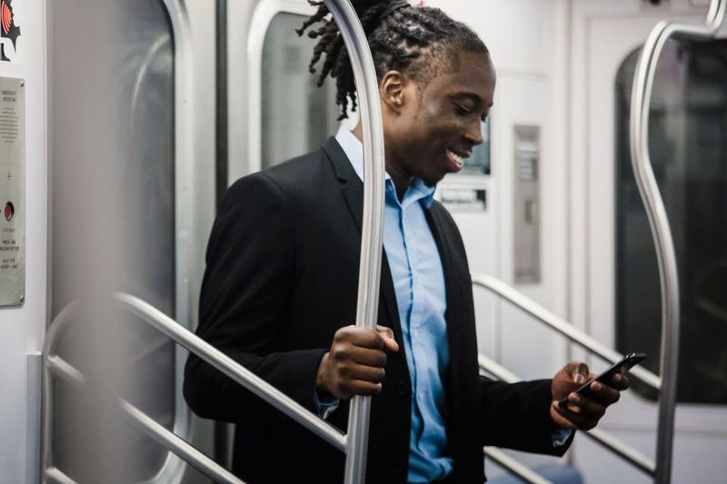 A man smiling at his phone